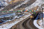 UP 8664, 9021, 7781 (SD70ACE, SD70ACE, C45ACCTE) lead an eastbound stack train approaching the Echo Rd. OHB in Emory, Utah. February 19, 2022 {Winter Echofest}